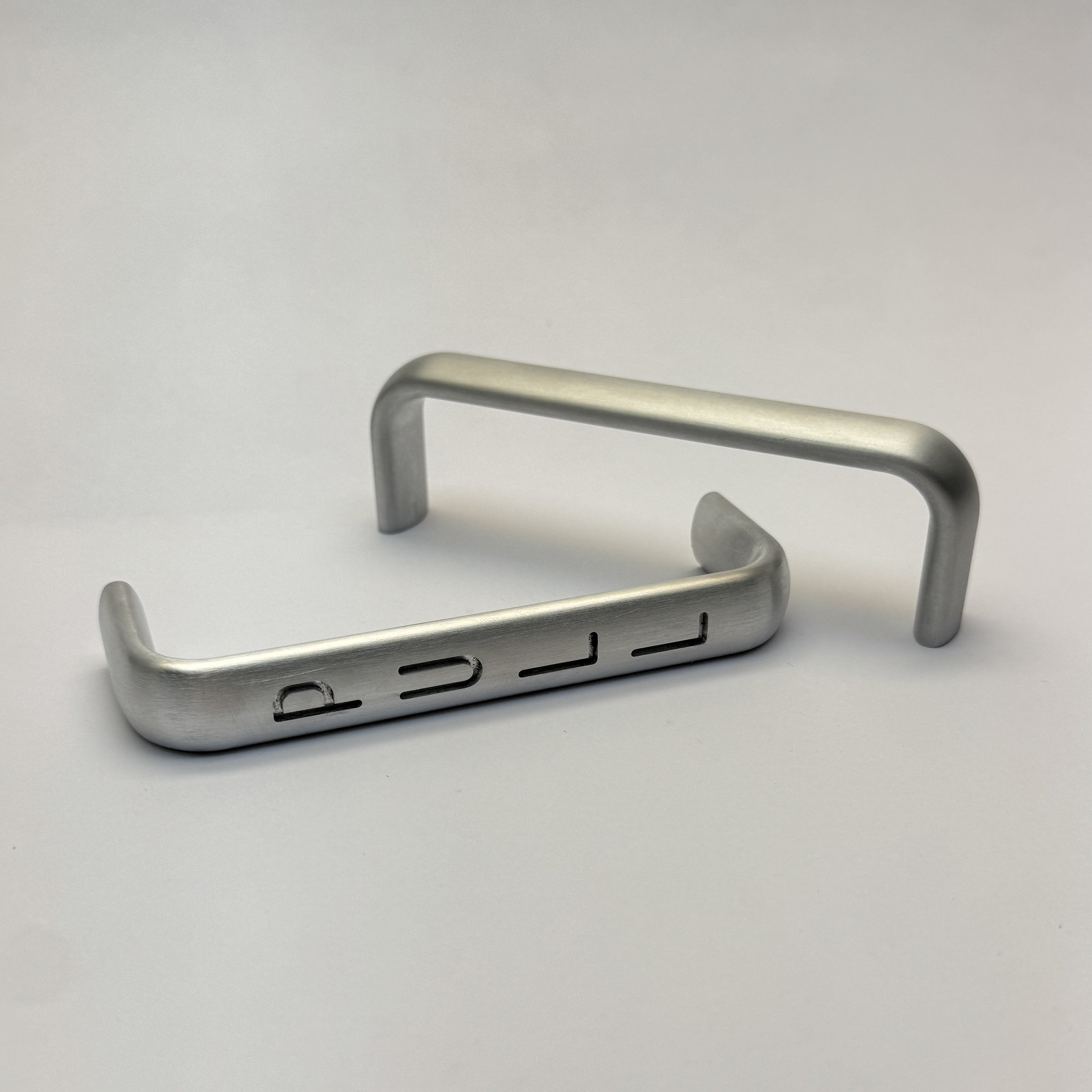 CNC-machined and engraved aluminum handle